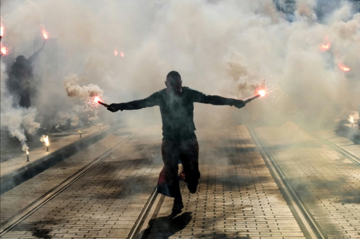 Un manifestant tient des fusées éclairantes lors d&#39;une manifestation à Nice